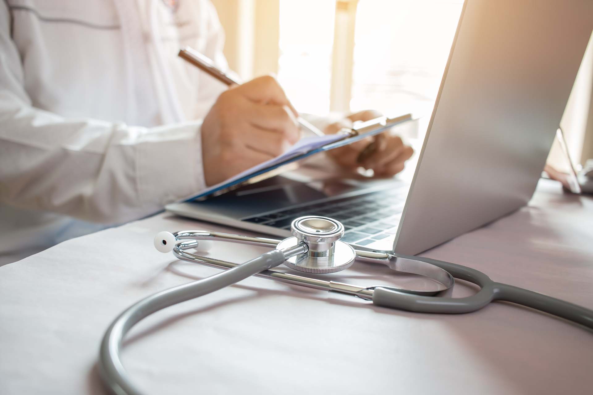 Medicine doctor's writing on laptop in medical office.Focus stet